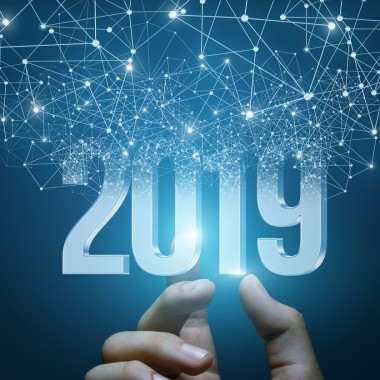 Hand shows the numbers 2019 emerging from the network connections.